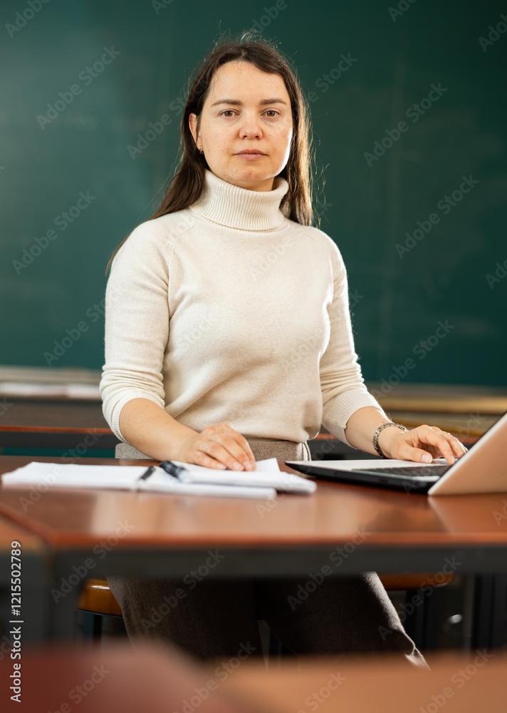 Portrait of a concentrated girl student preparing for classes in a university auditorium Portrait of a concentrated girl student preparing for classes in a university auditorium