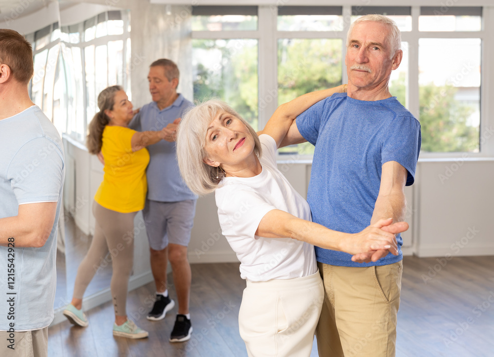 Elderly man and elderly woman dance ballroom dance waltz in studio Elderly man and elderly woman dance ballroom dance waltz in studio