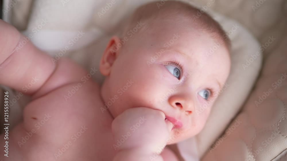 Cute newborn baby boy sitting in a white high chair next to a window. A joyful lifestyle of a happy mixed-race family. A young asian woman and active healthy baby with blue eyes in a rabbit costume Cute newborn baby boy sitting in a white high chair next to a window. A joyful lifestyle of a happy mixed-race family. A young asian woman and active healthy baby with blue eyes in a rabbit costume