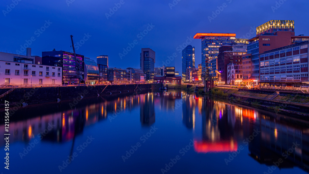 Dusseldorf, Germany. Cityscape image of Düsseldorf with the Media Harbour and reflection in the Rhine river, at the evening Dusseldorf, Germany. Cityscape image of Düsseldorf with the Media Harbour and reflection in the Rhine river, at the evening
