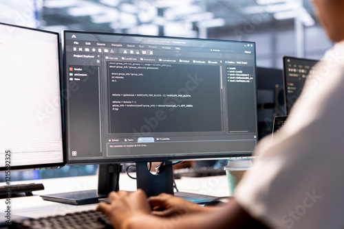 Developer in data center workspace using diagnostic tools and system monitoring software to identify root cause of errors. Woman working in server farm, mending equipment photo
