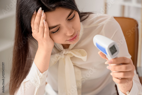 Sick young woman measuring ...