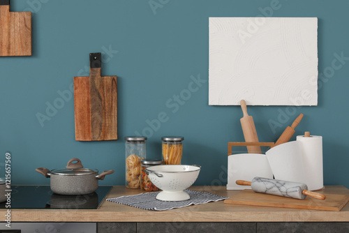 Grey kitchen counters with cutting boards, colander and utensils photo