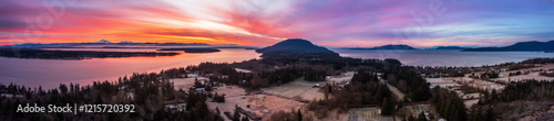 Panoramic aerial view of the south end of Lummi Island, Washington, during a glorious sunrise. Dramatic clouds and a frosty landscape make for a unique view of this rural area in the Pacific Northwest photo