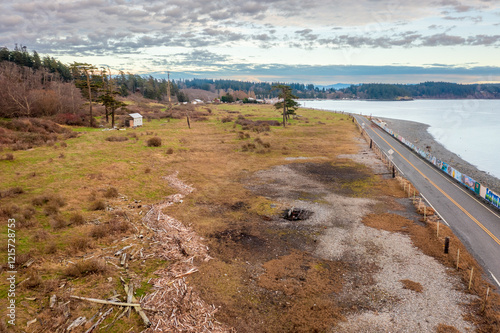 Aerial drone view of the west side of Lummi Island, Washington. The coastline of this island borders on Rosario Strait and the Salish Sea with Orcas Island to the west in the background. photo