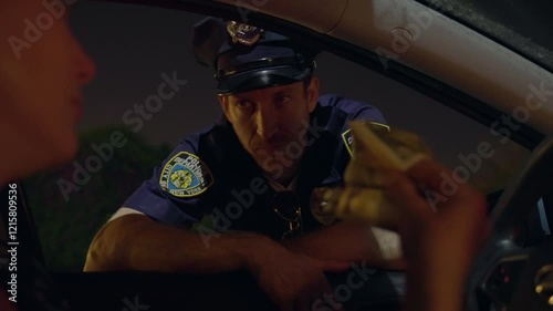 Police officer leans into the window of a car, Driver offers money. The officer refusing the bribe. Cop rejection of unethical behavior, emphasizing professionalism during a routine traffic stop.