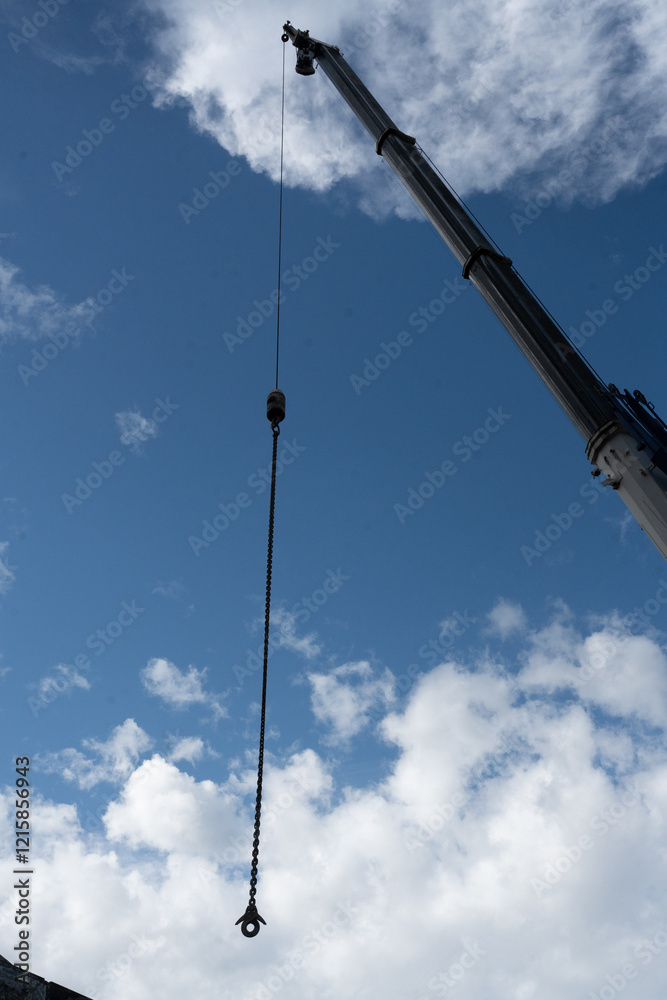 Construction tower cranes on a building site with blue sky background. Construction tower cranes on a building site with blue sky background.