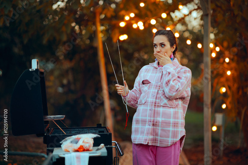 Vegetarian Cook Feeling Disgusted by Meat at Grill Party. Vegan girl unable to prepare meat for the barbecue feeling nauseous 
 photo