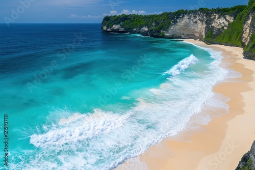 Turquoise waves crash on secluded tropical beach cliff