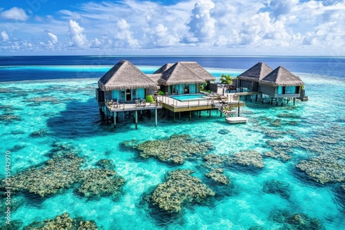 Overwater bungalows, turquoise lagoon, coral reef, sunny Maldives, vacation photo