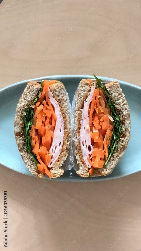 A delicious sandwich with layers of fresh ingredients like lettuce, tomato, cheese, and deli meats, all stacked between two slices of soft bread. Perfect for a quick and satisfying meal.
A delicious sandwich with layers of fresh ingredients like lettuce, tomato, cheese, and deli meats, all stacked between two slices of soft bread. Perfect for a quick and satisfying meal.