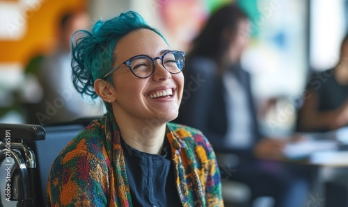 Happy female employee with blue hair and glasses in a wheelchair laughing during office team meeting promoting inclusion and diversity at accessible workplace, daytime, celebratory and, Generative AI