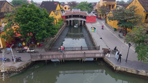 Aerial view of Chua Cau or Japanese Covered ancient Bridge and River in Old city of Hoi An, Vietnam. Vietnamese heritage and culture in Hoian ancient town