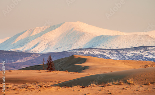 Russia. Beautiful scenery of the northernmost desert in the world. View of the Kodar Ridge. Chara sands. The region of baikaL Kodar National natural park.