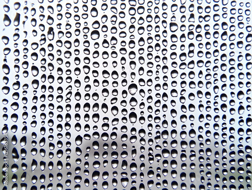 Close-up of Water Droplets forms a Textured Pattern on a Surface Uniformly and Beautifully. photo