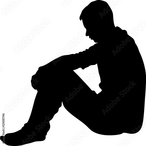 A man is sitting on the ground. He is wearing a black shirt and black pants. He is looking down