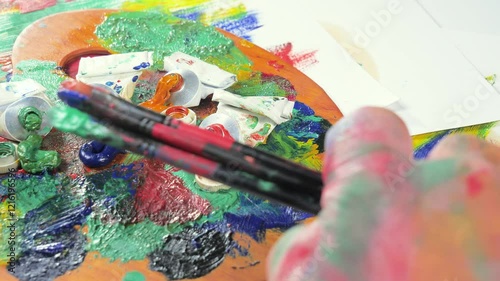 Wallpaper Mural The hands of the artist, work to create creative images in art. Art paints and brushes, applying multi-coloured strokes to the canvas using palette, gouache and watercolour. Torontodigital.ca