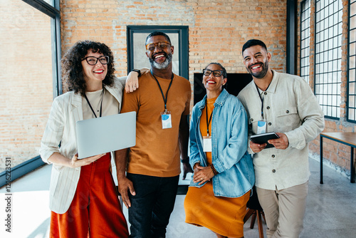 Diverse group of professionals smiling in a modern office setting