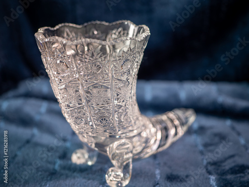 A beautiful hand-cut crystal vase in the shape of a boot. A crystal vase of this size is intended for medium-sized or smaller bouquets. It is a nice and valuable gift that will never lose its value. photo