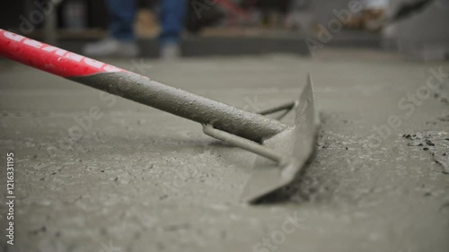 Leveling wet concrete with a tool