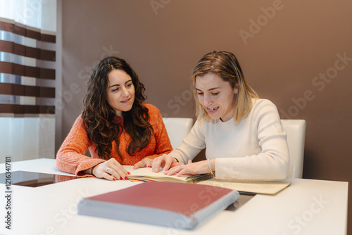 Blind woman reading a Braille book while sharing the experience with her friend, promoting inclusion, accessibility, and education