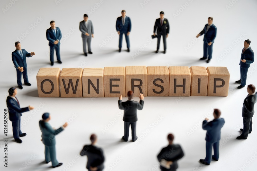 Businesspeople surrounding wooden blocks spelling 'Ownership', signifying shared responsibility and collaborative enterprise.