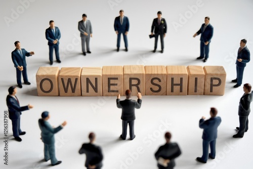 Obraz na płótnie Businesspeople surrounding wooden blocks spelling 'Ownership', signifying shared responsibility and collaborative enterprise. w salonie