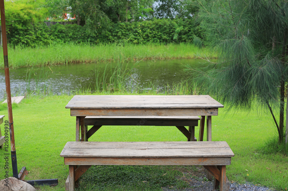 Wooden table and benches in the garden. Garden furniture for outdoor recreation. Wooden table and benches in the garden. Garden furniture for outdoor recreation.