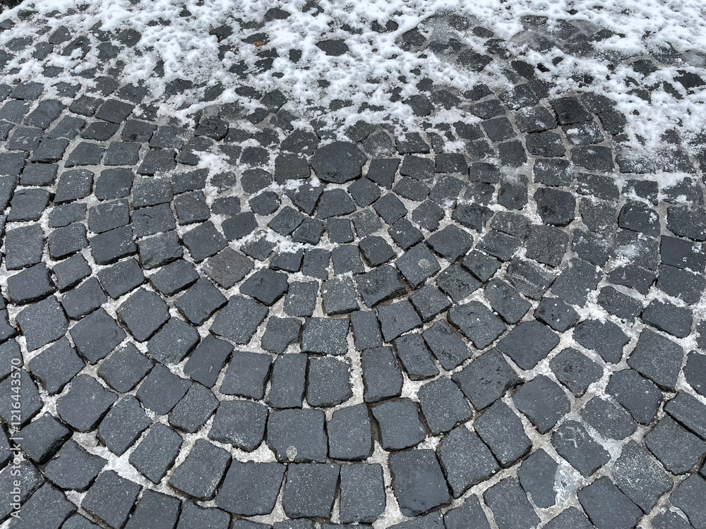 Snow lies on an old cobblestone pavement Snow lies on an old cobblestone pavement