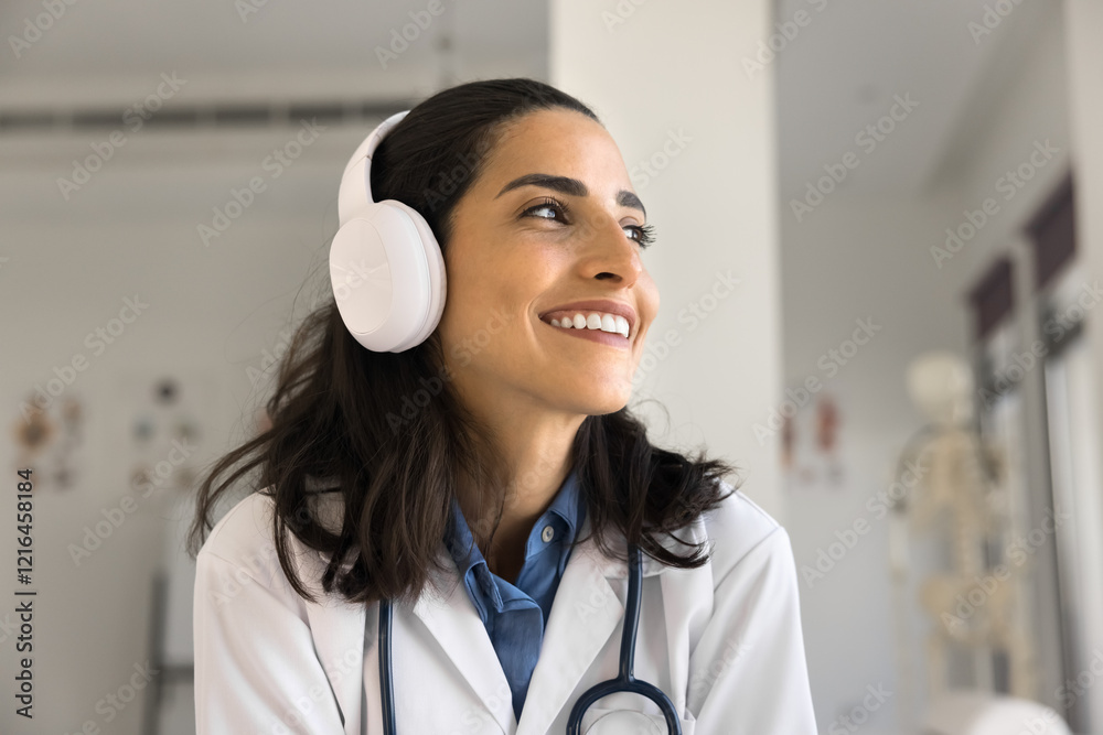 Telehealth service. Screen view smiling young female doctor medical call center worker in headset distracted from webcam consulting patient online on distance taking part in healthcare web conference