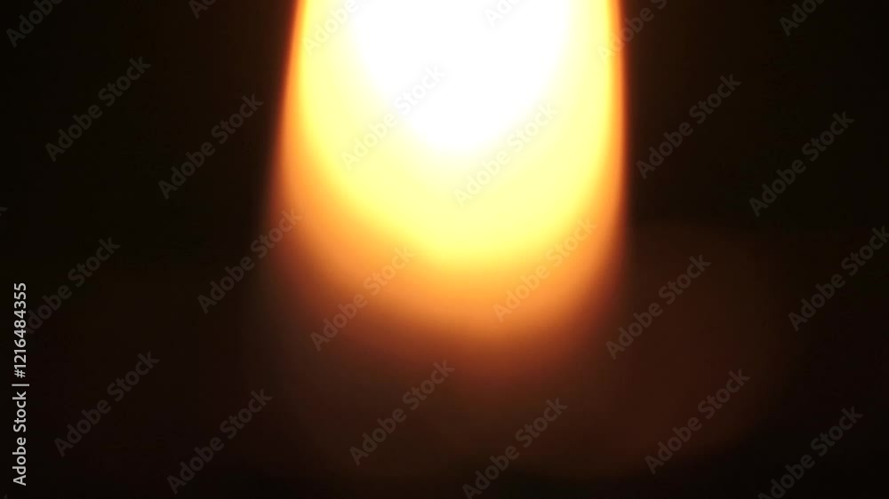 Defocused small flame on black background
