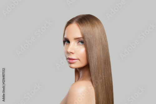 Lovely brunette woman looking at cemera, fashion beauty portrait. Attractive female model with long healthy hair photo