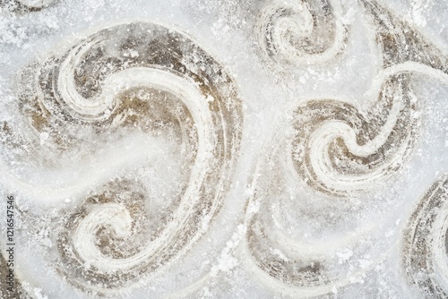 Swirling patterns on icy surface create an intriguing visual eff photo