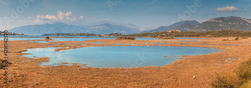 Breathtaking panoramic view of Tivat Solila nature reserve with its serene wetlands, framed by the imposing mountains photo