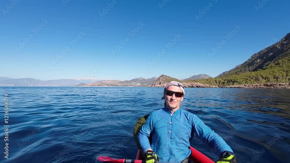 A man paddles in a kayak. The Mediterranean Sea. Turkey A man paddles in a kayak. The Mediterranean Sea. Turkey
