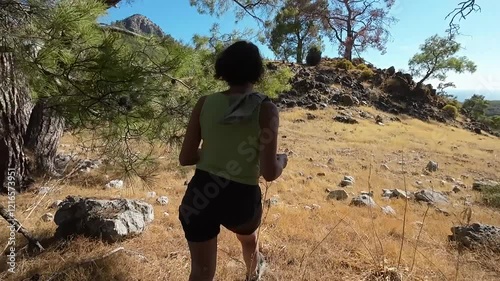 The girl climbs to the top of the mountain at a fast pace