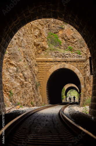 Railway tunnel and walking people silhouette photo