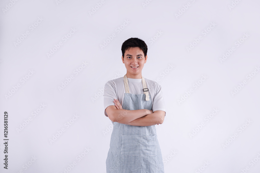 Portrait of young Asian man wearing apron and posing on white background Portrait of young Asian man wearing apron and posing on white background