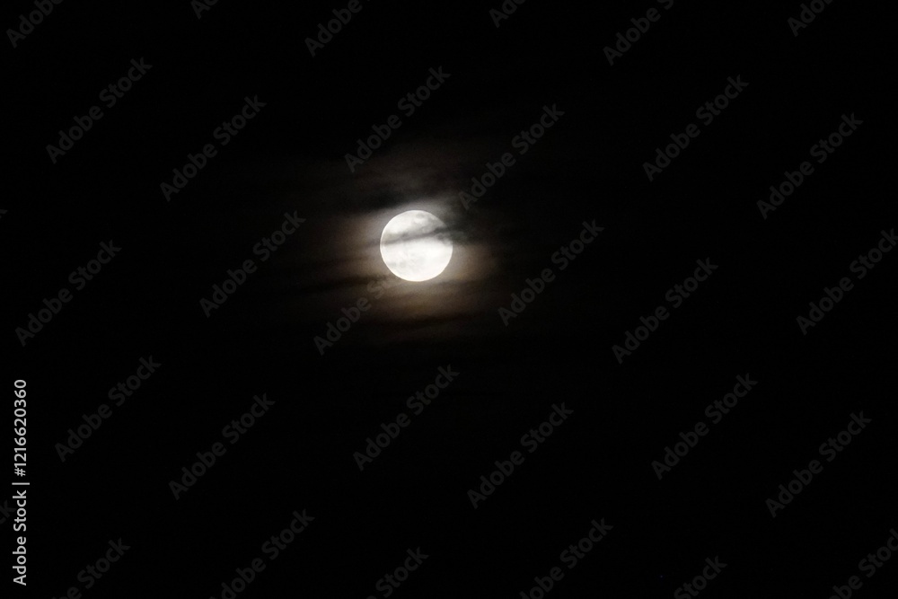 Moon Shining Through Clouds in a Dark Sky. Moon Shining Through Clouds in a Dark Sky.