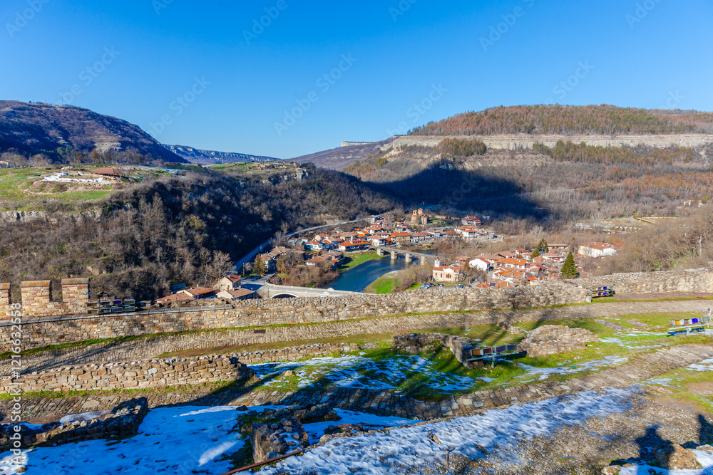 Tsarevets Fortress on a hill with a cloudy sky in the background
