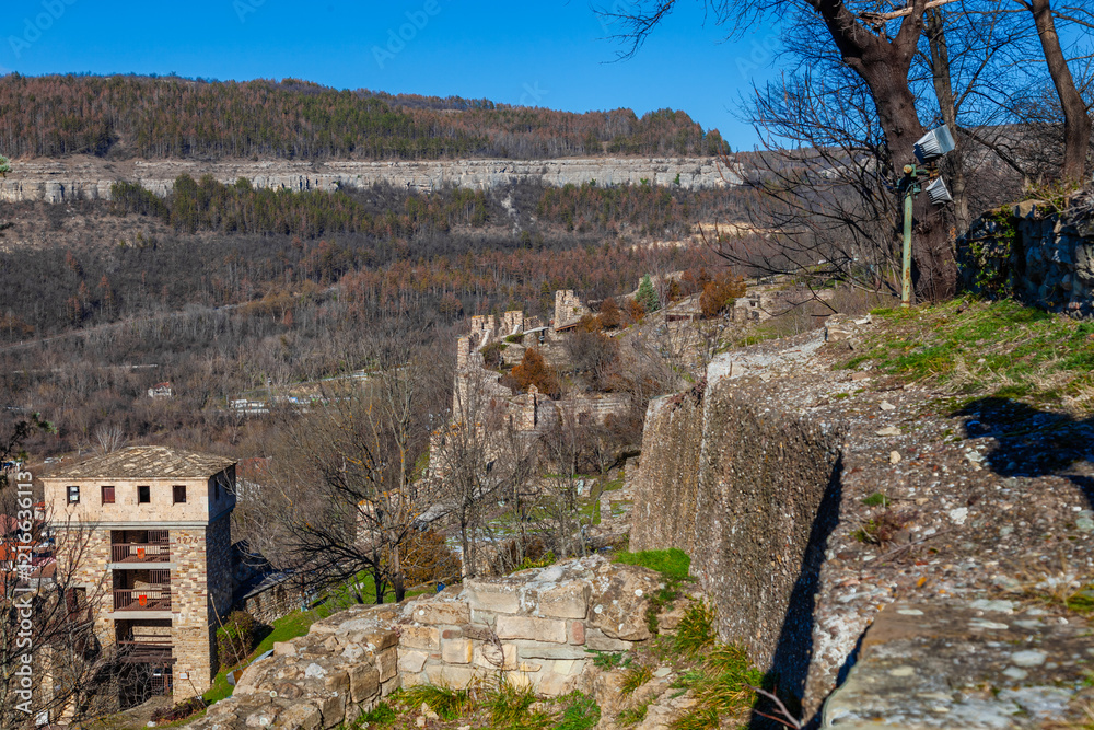 Tsarevets Fortress on a hill with a cloudy sky in the background