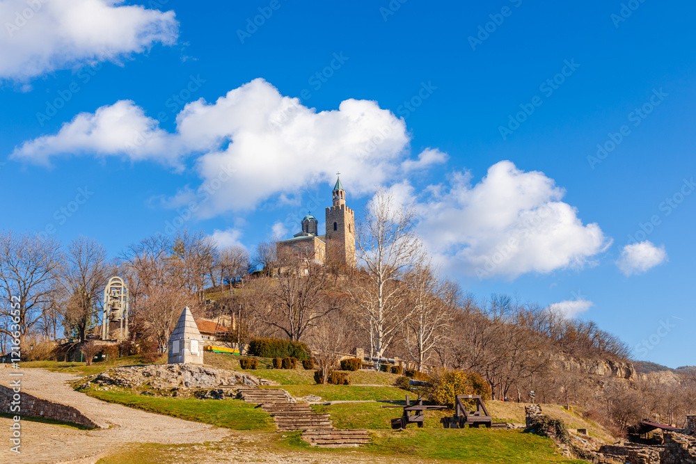 Tsarevets Fortress on a hill with a cloudy sky in the background