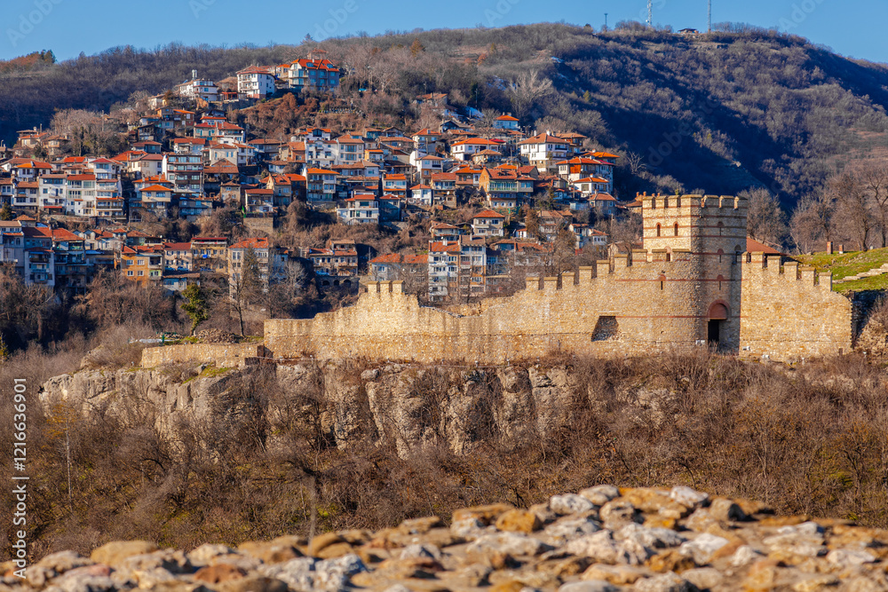Tsarevets Fortress on a hill with a cloudy sky in the background