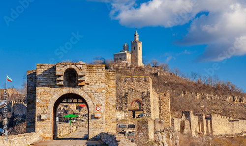 Tsarevets Fortress on a hill with a cloudy sky in the background