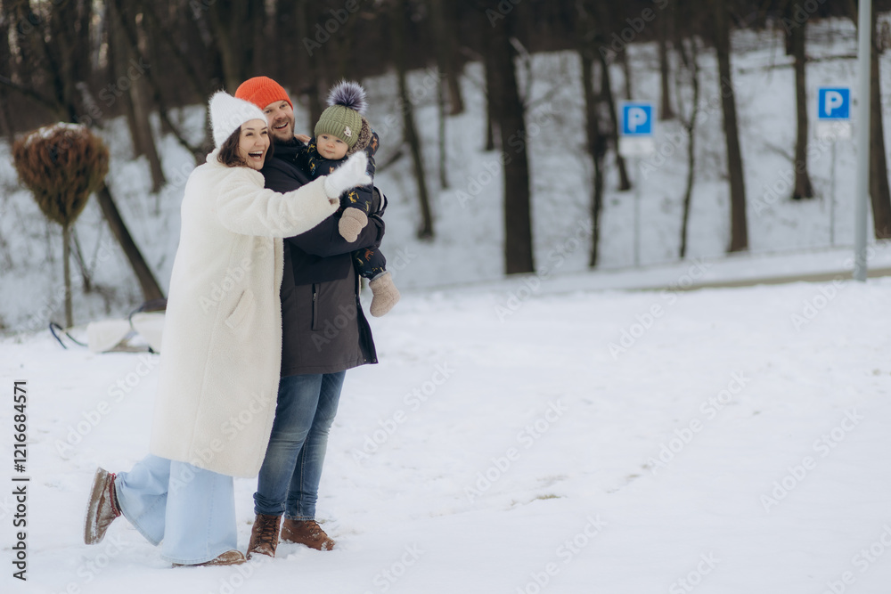 Young parents walking with their child in winter Young parents walking with their child in winter