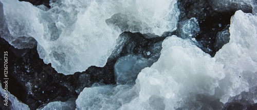 Black ink and salt crystallization create intricate textured patterns on a grainy surface