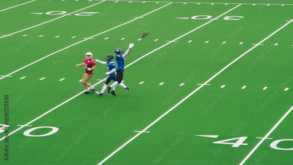 American Football Players Face Each Other On the Field. Athlete Making a Big Catch in Front of an Opponent American Football Players Face Each Other On the Field. Athlete Making a Big Catch in Front of an Opponent