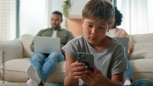 Gadget addicted family with devices at home multiracial mom and dad using laptops addict work ignoring sad child little boy son bored kid with phone smartphone on floor lack parents attention custody