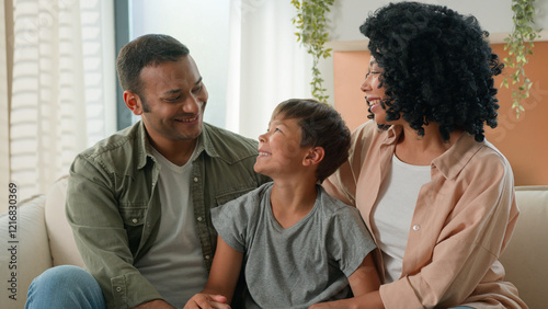African American mother and father loving mum dad family portrait multiracial couple parents and Caucasian adopted child kid looking at each other smiling hug adorable cute little boy son childcare