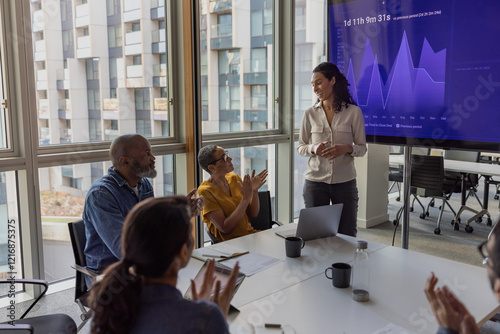 African American businesswoman being applauded for her presentation in a corporate meeting